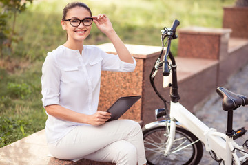 Fototapeta premium Positive woman resting in the street