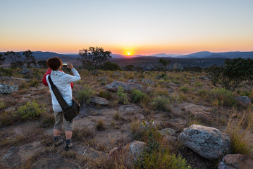 Obraz premium Tourist taking photo with smartphone at sunset at Blyde River Canyon, famous travel destination in South Africa.