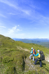 Obraz premium Summer hiking in the mountains with a backpack .