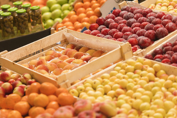 Counter with fruit in wooden boxes, background