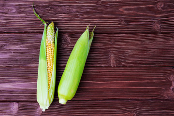 Fresh corn over rustic wooden background
