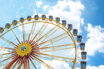 Ferris wheel on the background of blue sky