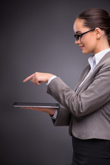 Businesswoman working on tablet computer in business concept