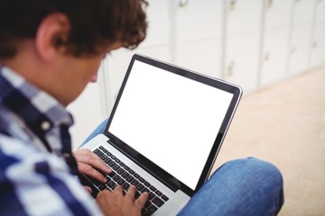 Student using laptop in locker room