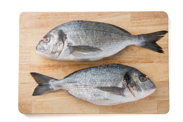 fish on a wooden board isolated on a white background