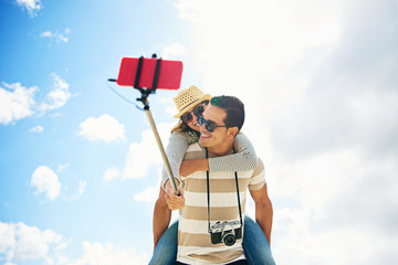 Fun couple taking a selfie piggy backing