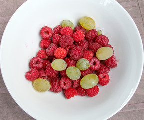 Raspberry and grape fruits, red , green and ripe