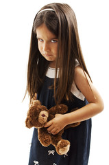 Closeup photo of little girl shows her furrowed brow and irritated frown. Isolated on white...