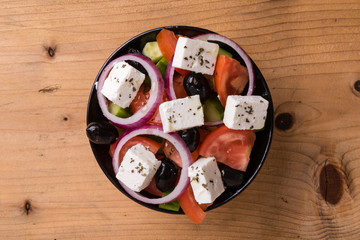 greek salad on wooden table