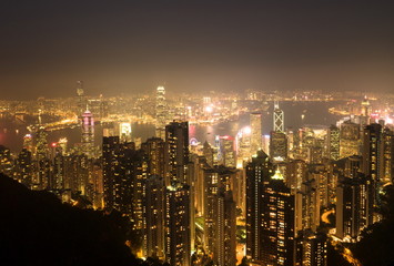 Skyscrapers of Hong Kong in China, Asia. Night view of the city life. Light of the buildings are very colorful, shining with warm tones.