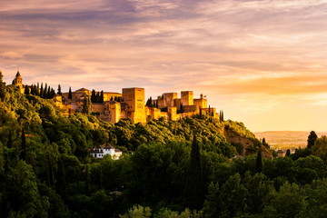 Beautiful sunset view of Spain's main tourist attraction, ancient arabic fortress of Alhambra, Granada, Spain - obrazy, fototapety, plakaty