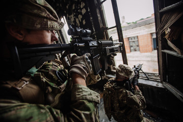 Soldiers on patrol in destroyed city. Military and rescue operation