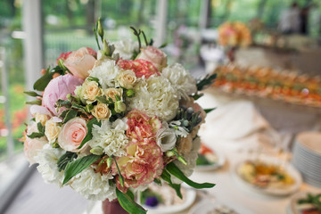 Bunch of the beautiful flowers on the wedding table