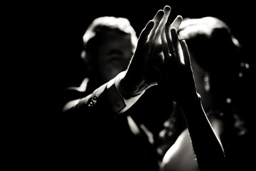 Black and white photo of the hands of the couple