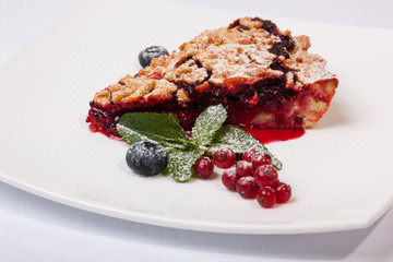 Sandy dough cake with jam and berries