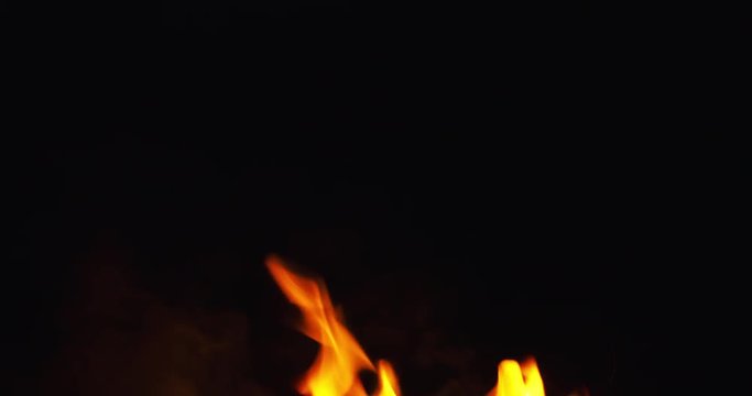 fire sparks from campfire over black background