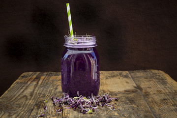 Glass of red cabbage smoothie with beetroot sprouts