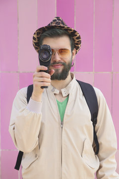 Man recording heart-shaped love lock on his hand with vintage video camera