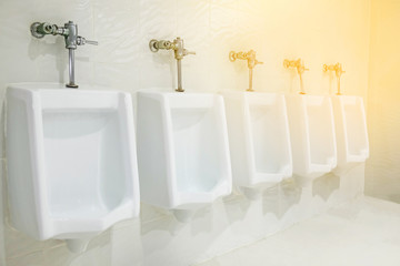 Fototapeta na wymiar white porcelain urinals in public toilet