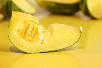Yellow and ripe pumpkin lie on a bright background