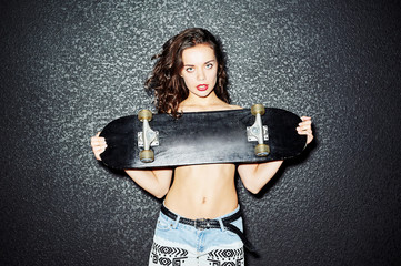 Fashion portrait of stylish girl with skateboard