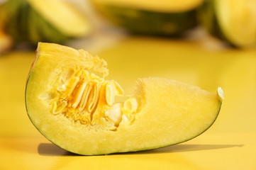 Yellow and ripe pumpkin lie on a bright background