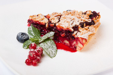 Sandy dough cake with jam and berries