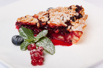 Sandy dough cake with jam and berries
