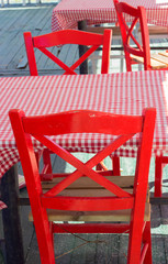 Empty red chairs in small restaurant