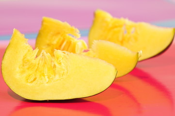 Yellow and ripe pumpkin lie on a bright background
