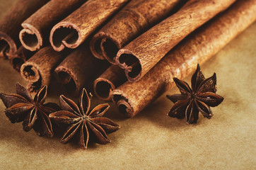 tinted image cinnamon sticks and three stars anise on paper back