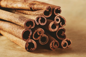 tinted image cinnamon sticks close-up on paper background horizo