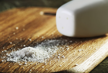 salt heap and shaker on a cutting board horizontal