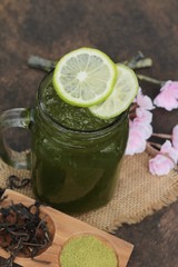 Iced green tea with lemon and matcha tea powder.