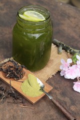 Iced green tea with lemon and matcha tea powder.