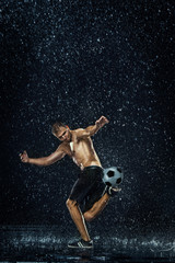 Fototapeta na wymiar Water drops around football player under water