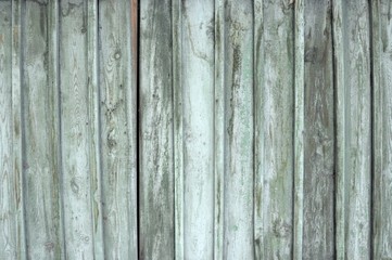 background consisting of old wooden boards with traces of peeling paint. partially tinted photo.