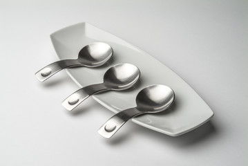 Porcelain tray with steel spoons for tapas