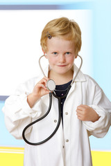Child with stethoscope and lab coat