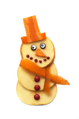 Food art creative concepts. Cute Christmas decoration made of fruits and vegetables over a white background.