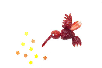 Food art creative concepts. Cute hummingbird made of strawberries with star fruits over a white...