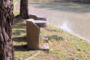 The marble bench outdoor at side of canal at the park.

