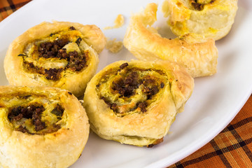 Fresh baked homemade beef pumpkin pinwheels.