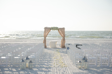 Beach wedding ceremony with arch