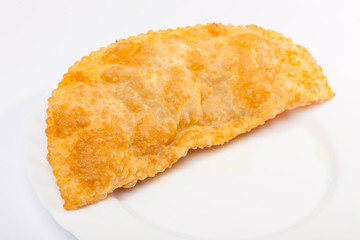 cheburek with lamb on white plate