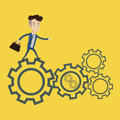 Businessman running on cogwheels.