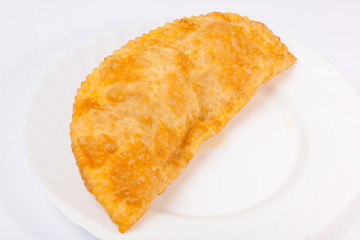 cheburek with lamb on white plate