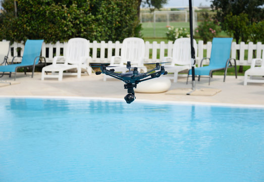 drone hovering over swimming pool