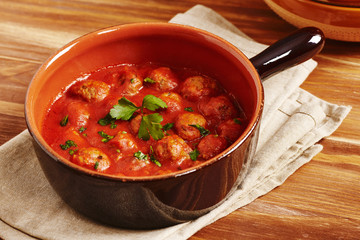 Meatball with tomato sauce in a pot, country style