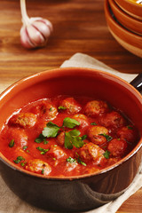 Meatball with tomato sauce in a pot, country style